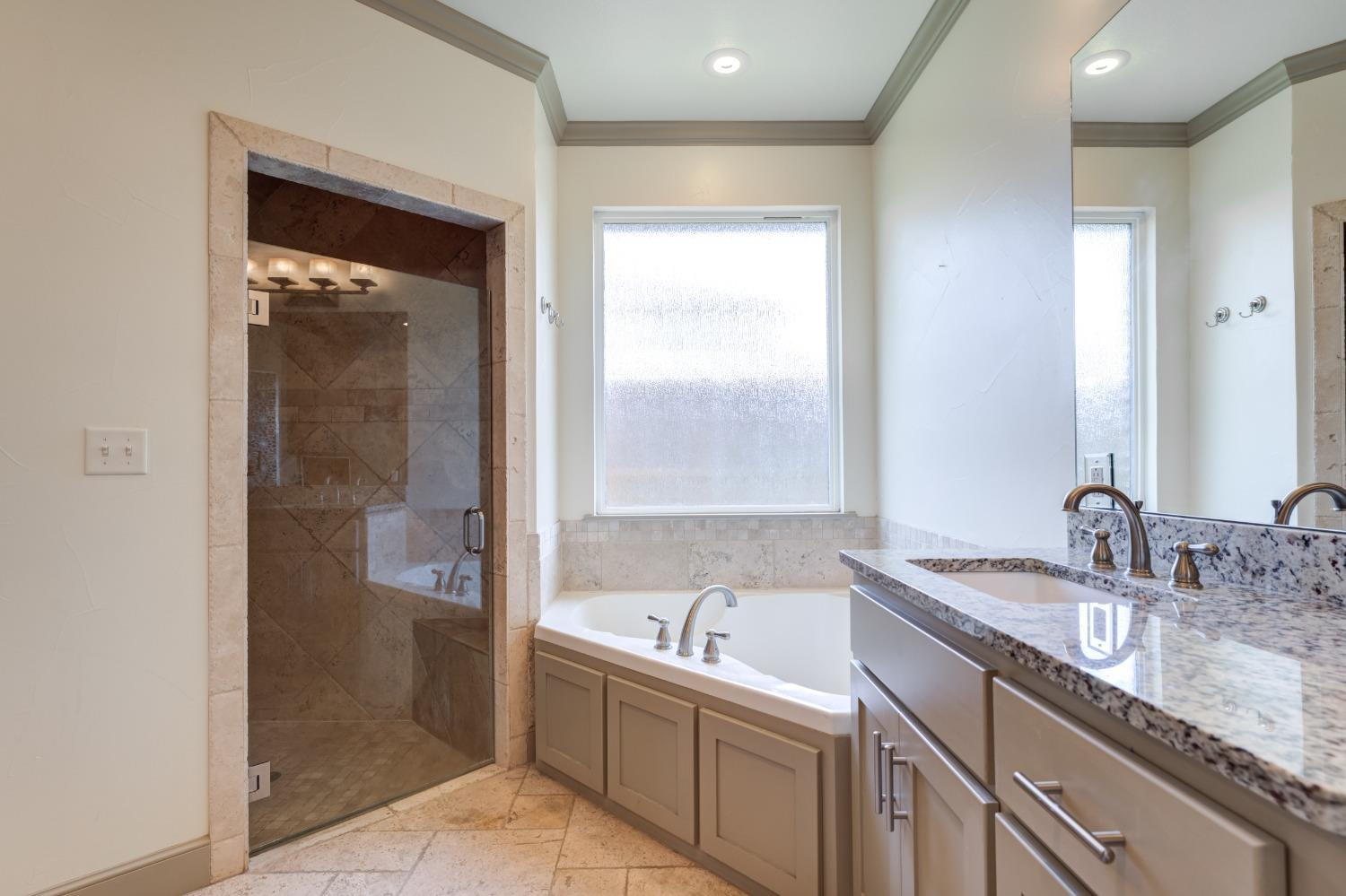 4808 115th Street Lubbock, TX 79424 - Photo 20 of 50 a bathroom with a granite countertop sink and a mirror