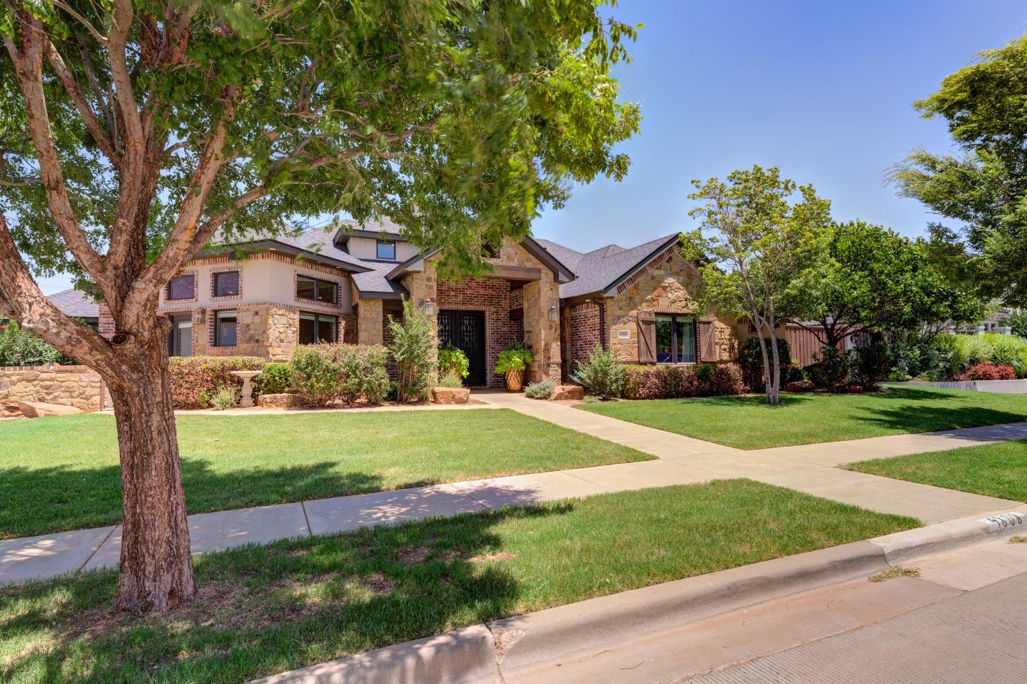 4808 115th Street Lubbock, TX 79424 - Photo 2 of 50 a front view of a house with a yard