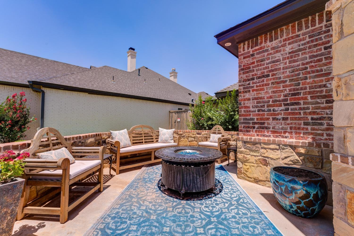 4808 115th Street Lubbock, TX 79424 - Photo 25 of 50 a backyard of a house with fire pit and outdoor seating