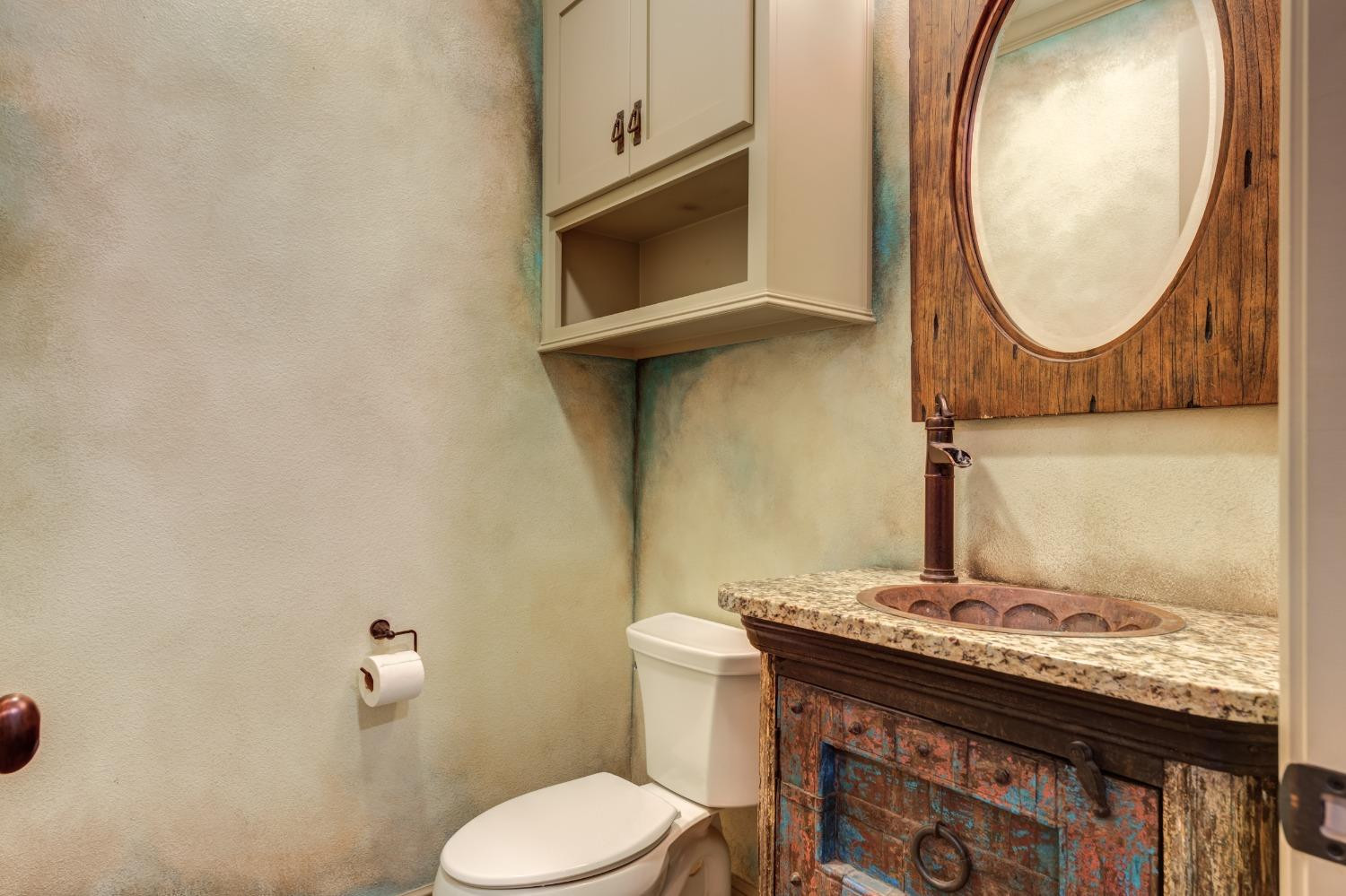 4808 115th Street Lubbock, TX 79424 - Photo 28 of 50 a bathroom with a granite countertop toilet and a sink