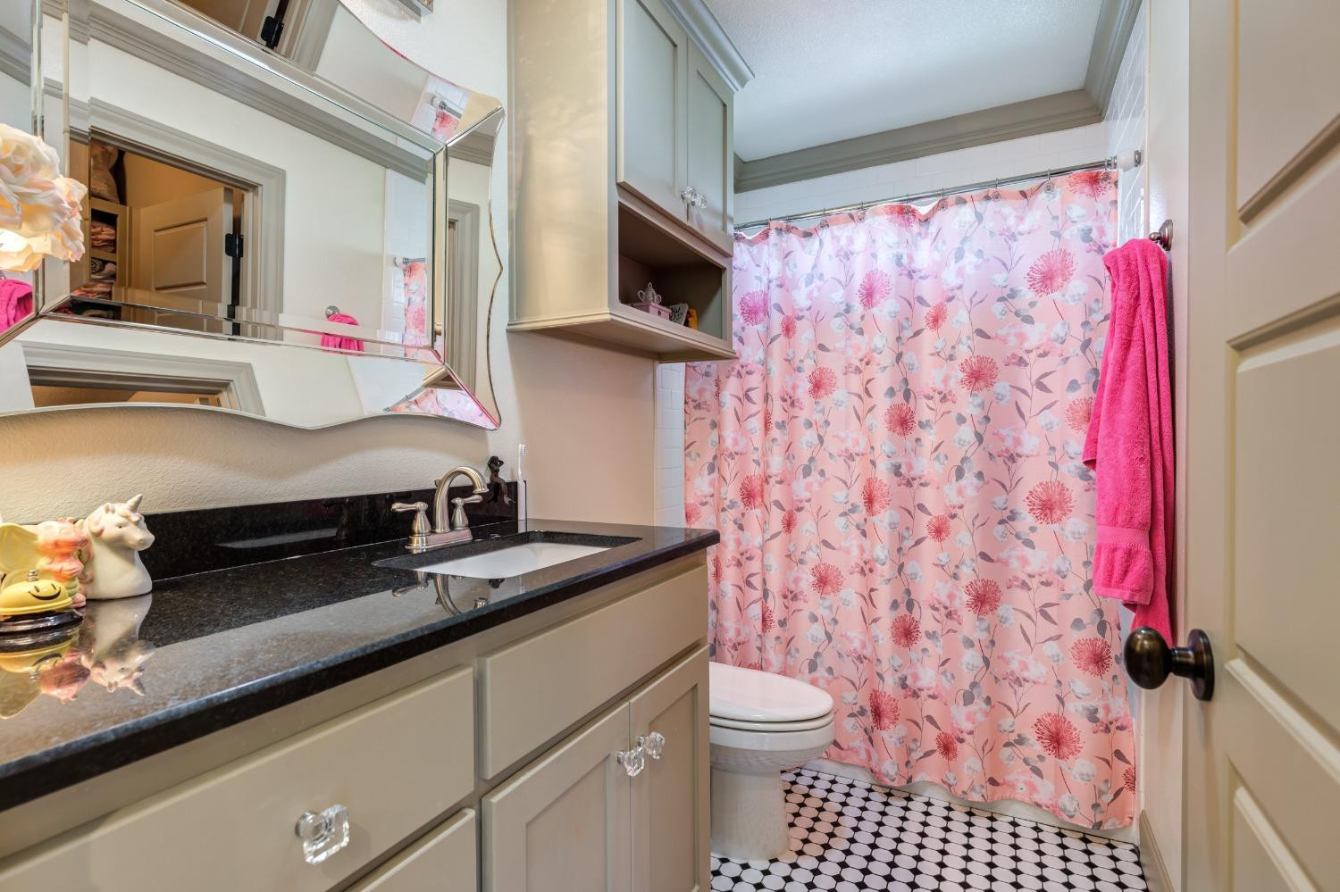 4808 115th Street Lubbock, TX 79424 - Photo 36 of 50 a bathroom with a sink toilet vanity and shower