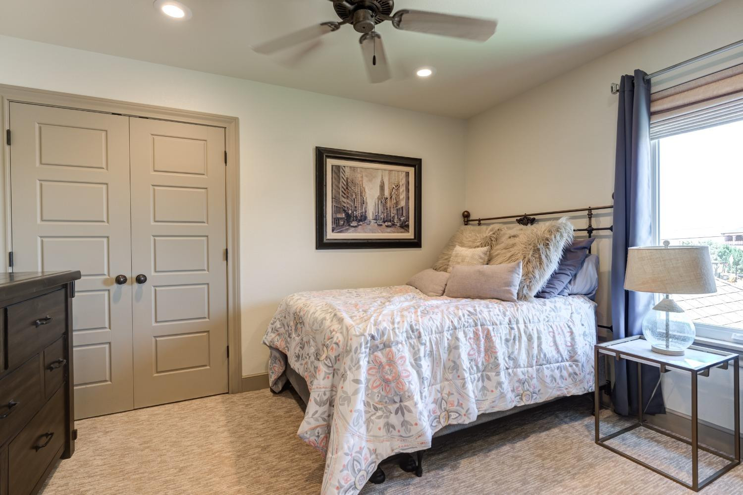 4808 115th Street Lubbock, TX 79424 - Photo 37 of 50 a bedroom with a bed and a chandelier