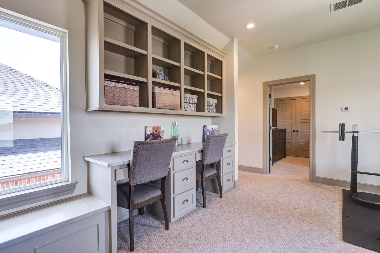 4808 115th Street Lubbock, TX 79424 - Photo 40 of 50 a view of a workspace with furniture and a window