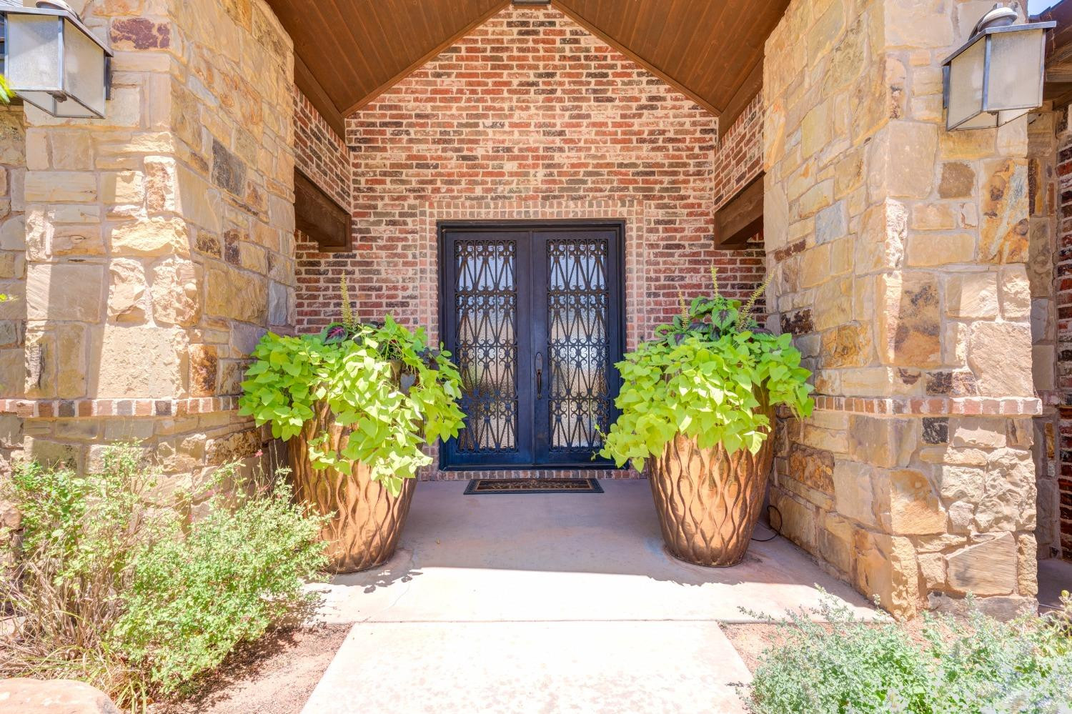 4808 115th Street Lubbock, TX 79424 - Photo 4 of 50 a view of front door with potted plants