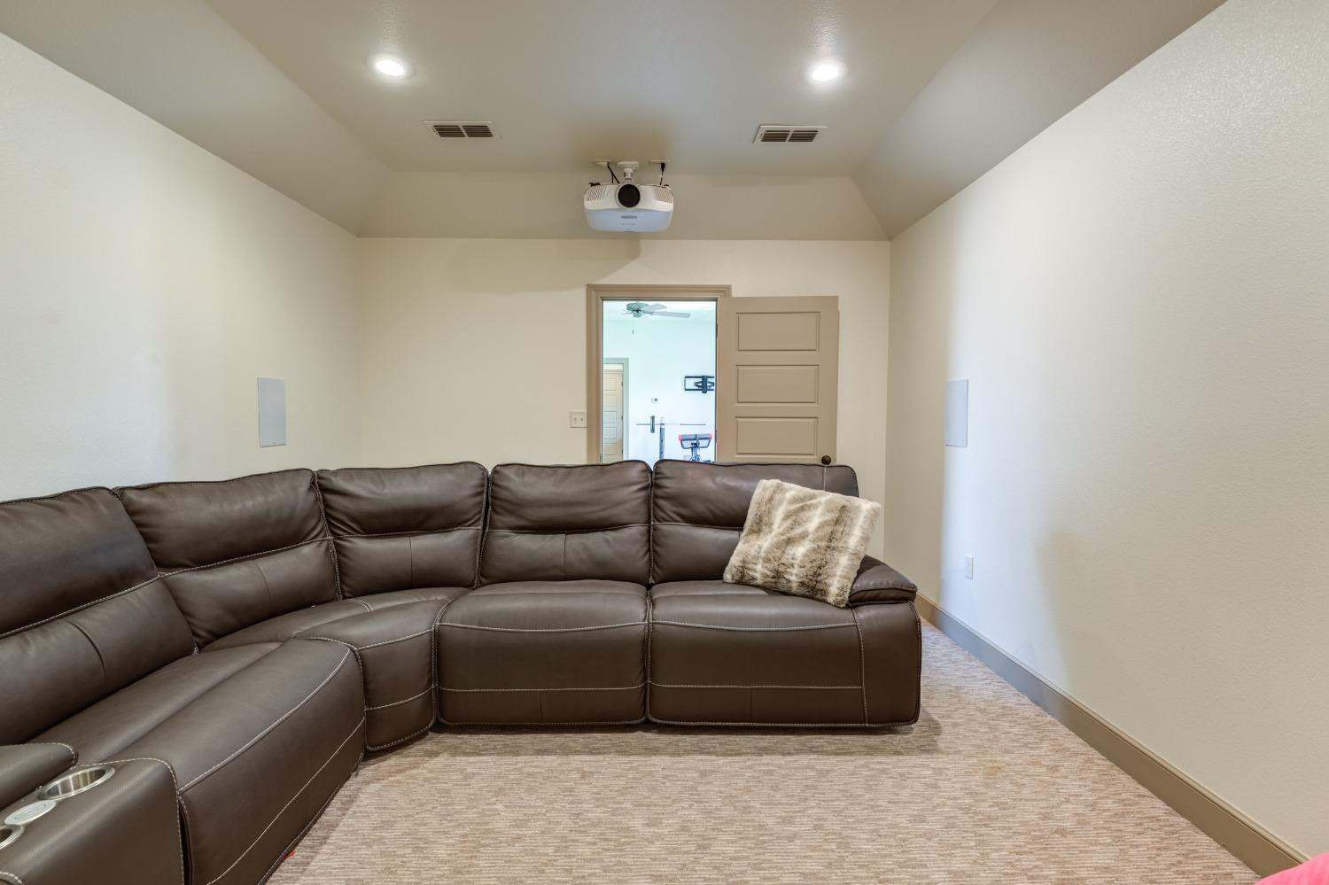 4808 115th Street Lubbock, TX 79424 - Photo 43 of 50 a living room with furniture and a chandelier