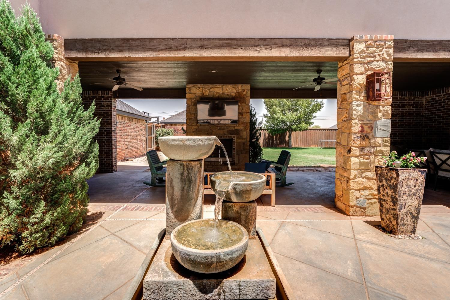 4808 115th Street Lubbock, TX 79424 - Photo 44 of 50 a view of a patio with table and chairs potted plants with floor to ceiling window and potted plants
