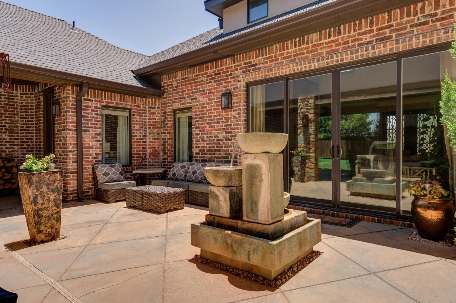 4808 115th Street Lubbock, TX 79424 - Photo 46 of 50 a view of a patio with table and chairs and potted plants