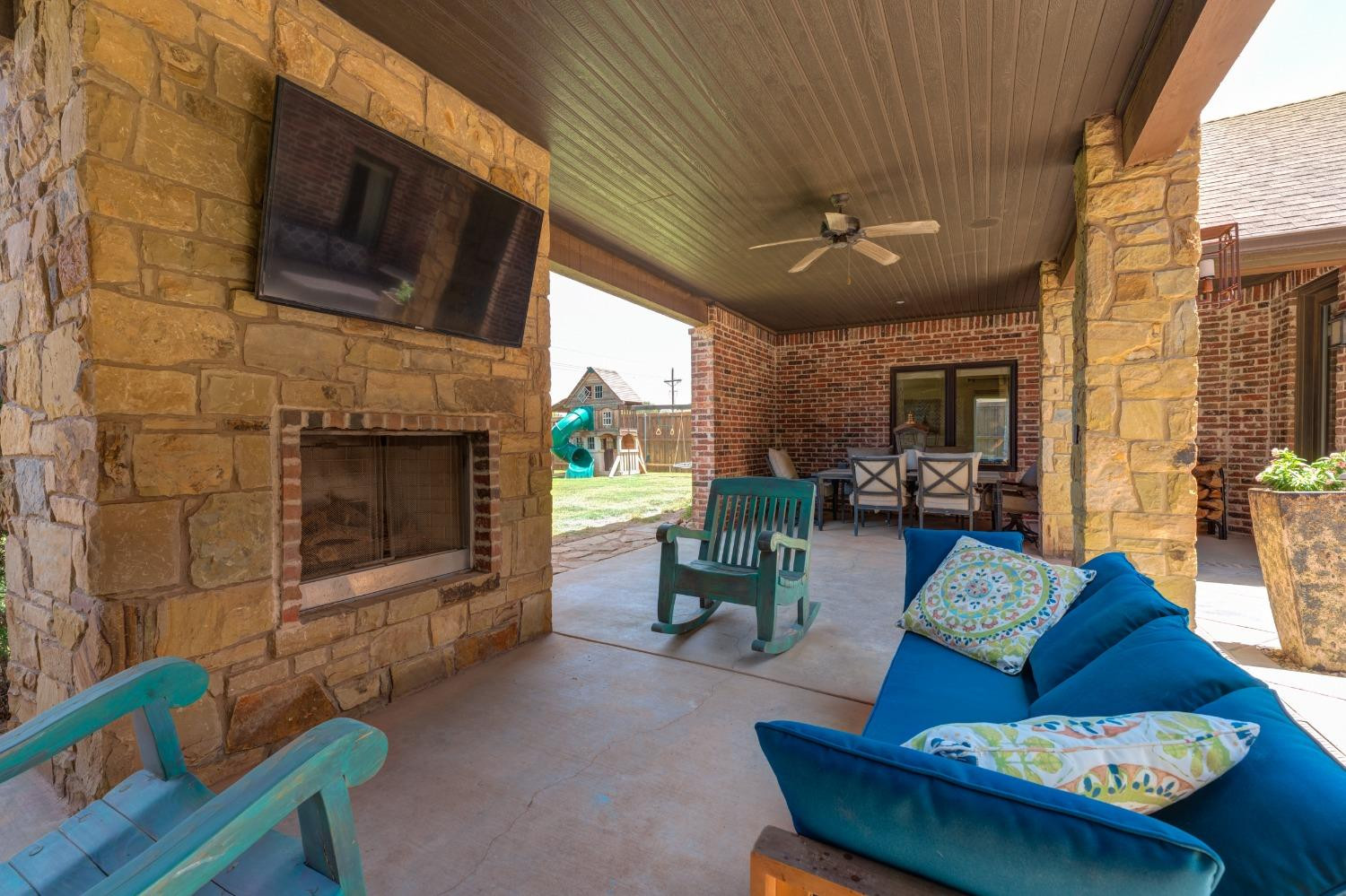 4808 115th Street Lubbock, TX 79424 - Photo 47 of 50 a living room with furniture a flat screen tv and a fireplace