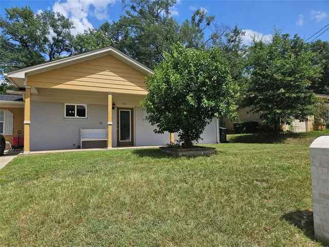 a front view of house with yard and trees
