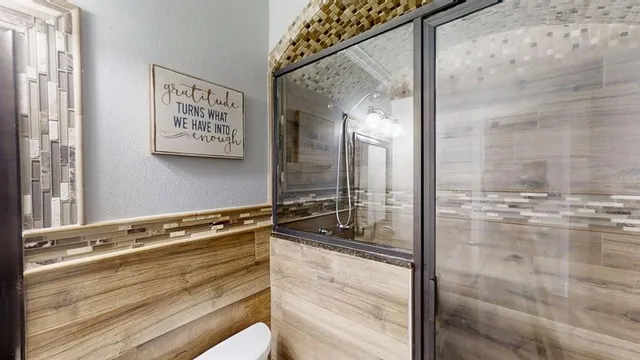 a bathroom with a shower and a sink