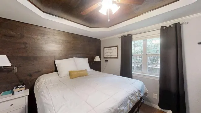 a bedroom with a large bed and a window