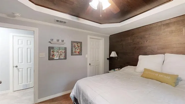 a bedroom with a bed and a painting on the wall