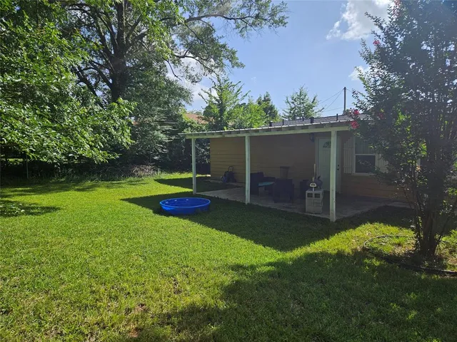 a view of a backyard with a garden and trees