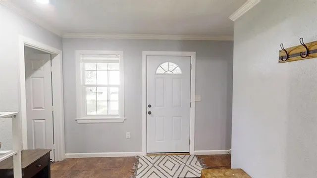a view of walk in closet with window and wooden floor
