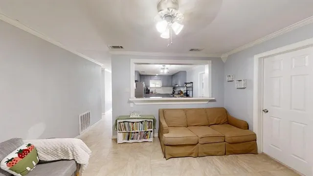 a living room with furniture and a chandelier