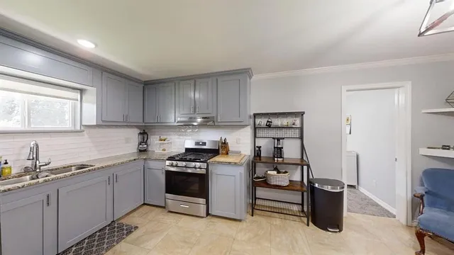 a kitchen with cabinets and window