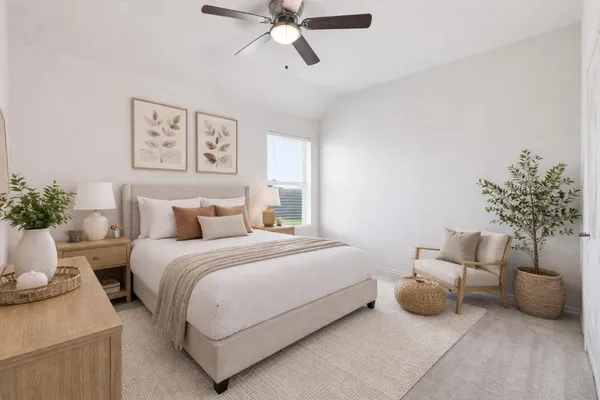 a bedroom with a bed and a potted plant