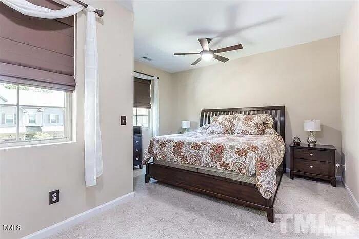 2436 Baslow Drive Apex, NC 27539 - Photo 11 of 21 a bedroom with a bed and a window