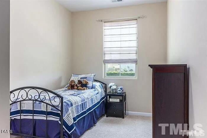 2436 Baslow Drive Apex, NC 27539 - Photo 12 of 21 a bedroom with a bed and window
