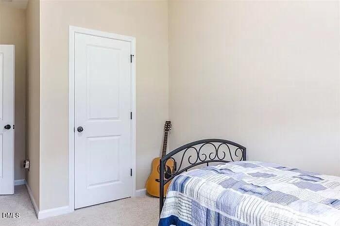 2436 Baslow Drive Apex, NC 27539 - Photo 13 of 21 a bedroom with a bed and a window