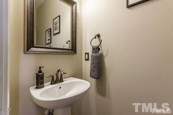 2436 Baslow Drive Apex, NC 27539 - Photo 15 of 21 a bathroom with a sink and a mirror