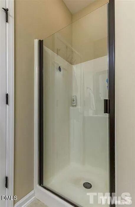 2436 Baslow Drive Apex, NC 27539 - Photo 16 of 21 a bathroom with a glass shower door