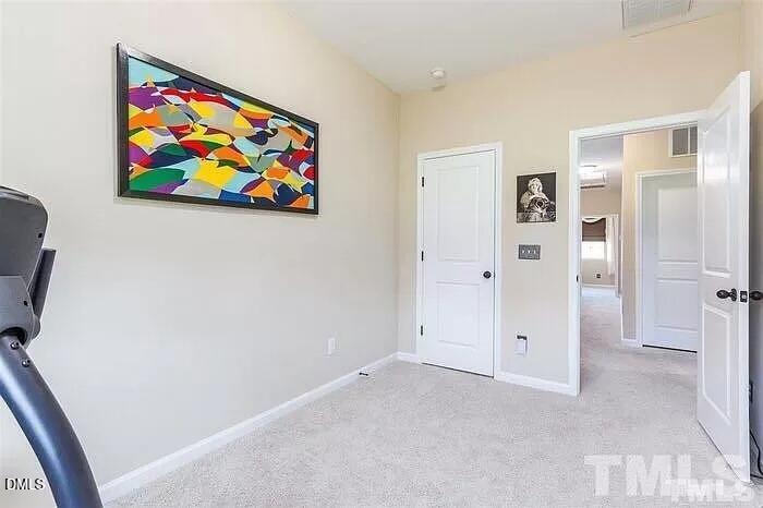 2436 Baslow Drive Apex, NC 27539 - Photo 8 of 21 an empty room with painting on the wall