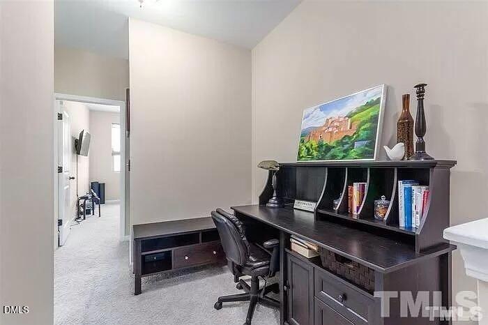 2436 Baslow Drive Apex, NC 27539 - Photo 10 of 21 a view of a workspace with furniture and a book shelf