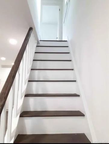 a close view of a refrigerator in kitchen and a wooden floor