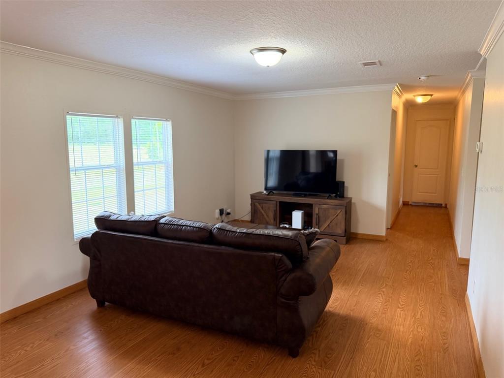 10730 198th Terrace O'Brien, FL 32071 - Photo 12 of 29 a living room with furniture and a flat screen tv