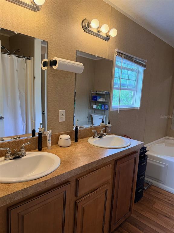 10730 198th Terrace O'Brien, FL 32071 - Photo 14 of 29 a bathroom with a double vanity sink and a mirror