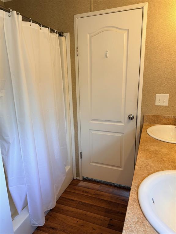 10730 198th Terrace O'Brien, FL 32071 - Photo 16 of 29 a bathroom with a sink a mirror and a shower curtain