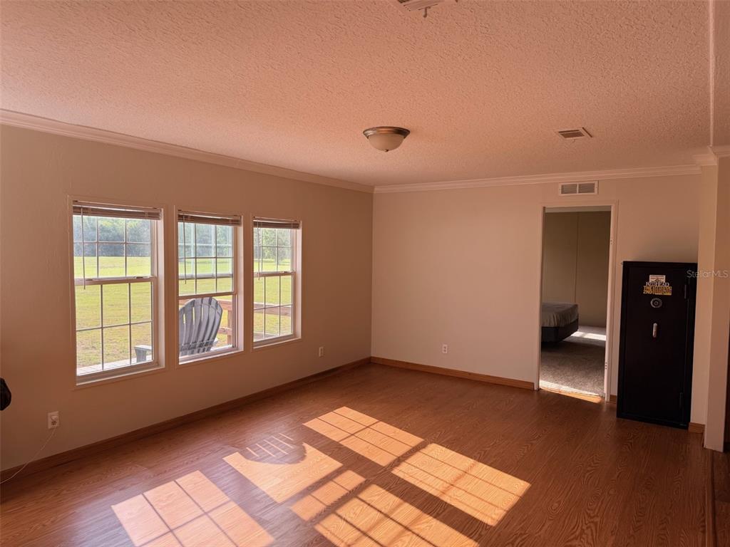 10730 198th Terrace O'Brien, FL 32071 - Photo 2 of 29 a view of empty room with wooden floor and fan