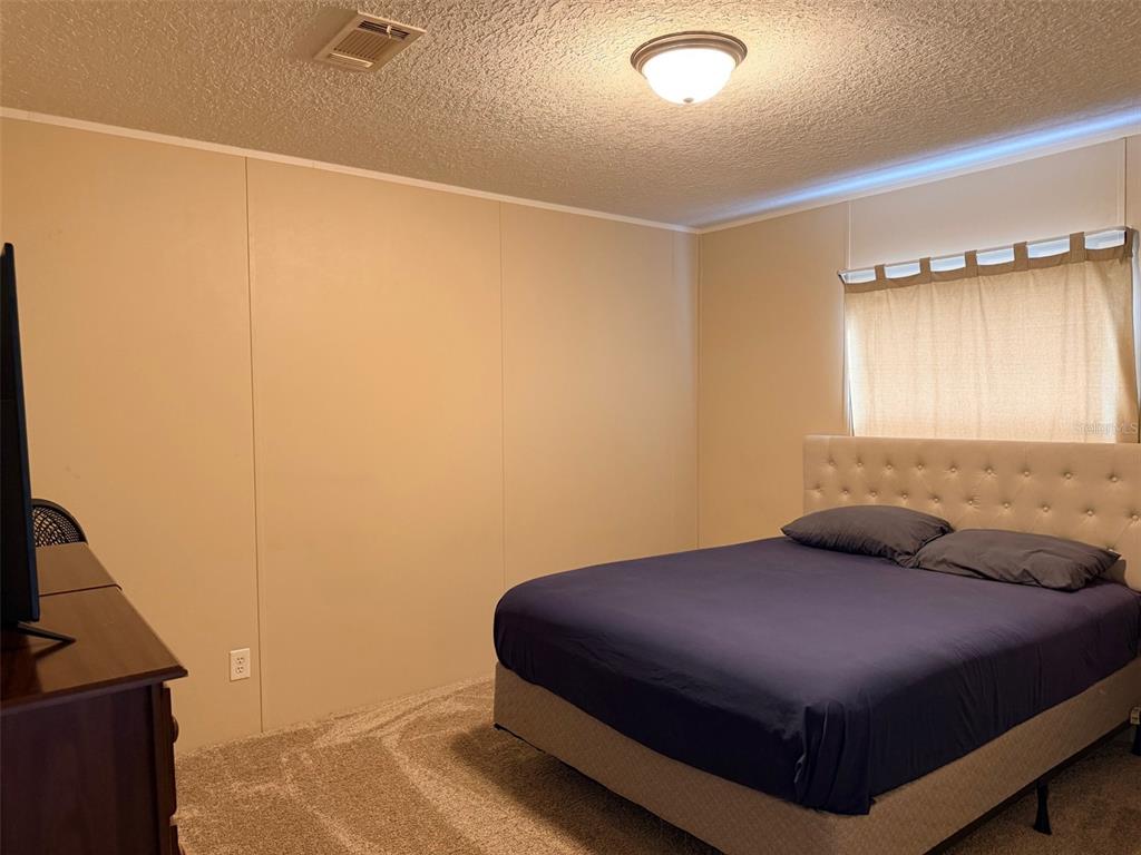 10730 198th Terrace O'Brien, FL 32071 - Photo 22 of 29 a bedroom with a bed and a window