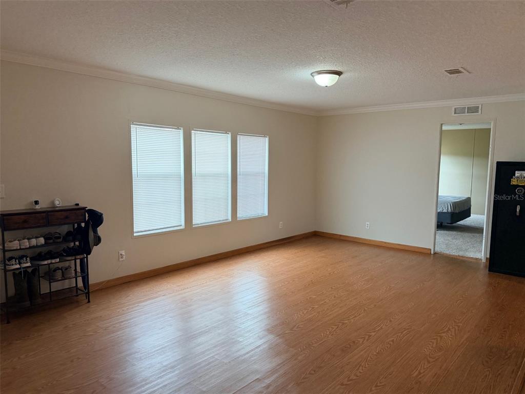 10730 198th Terrace O'Brien, FL 32071 - Photo 6 of 29 a view of empty room with wooden floor and windows
