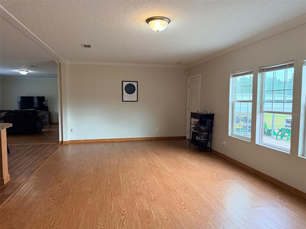 10730 198th Terrace O'Brien, FL 32071 - Photo 8 of 29 an empty room with wooden floor and windows