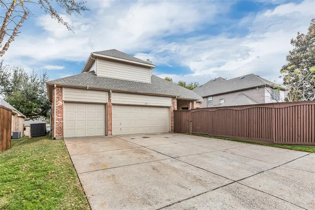 a view of backyard of house and garage