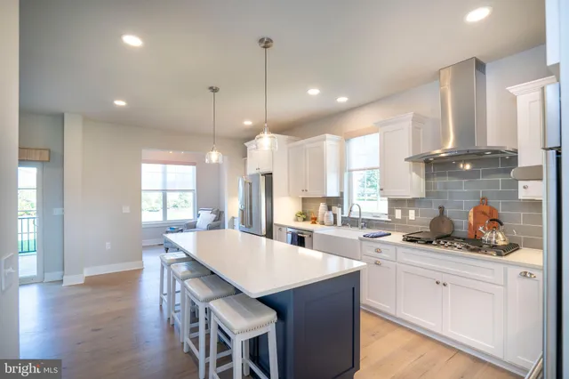 a living room with furniture a fireplace and a wooden floor