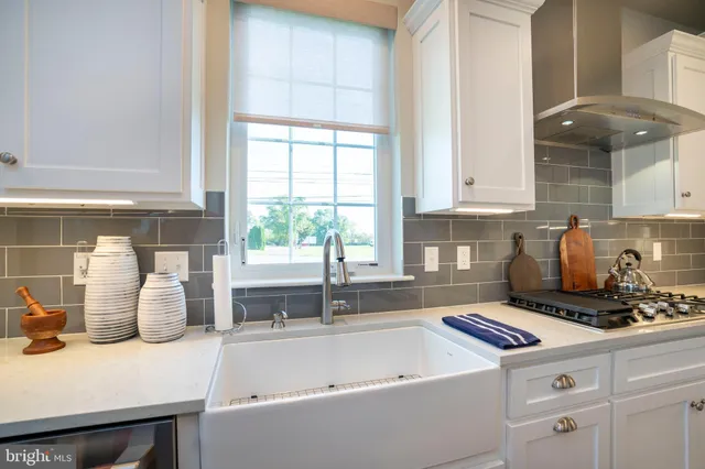 a living room with furniture fireplace and a large window
