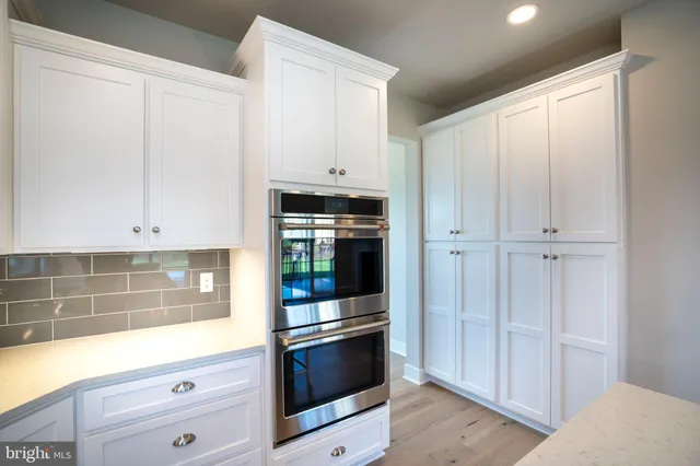 a bathroom with a granite countertop sink a toilet and a mirror