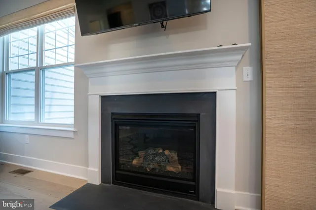 a view of a hallway with wooden floor and windows