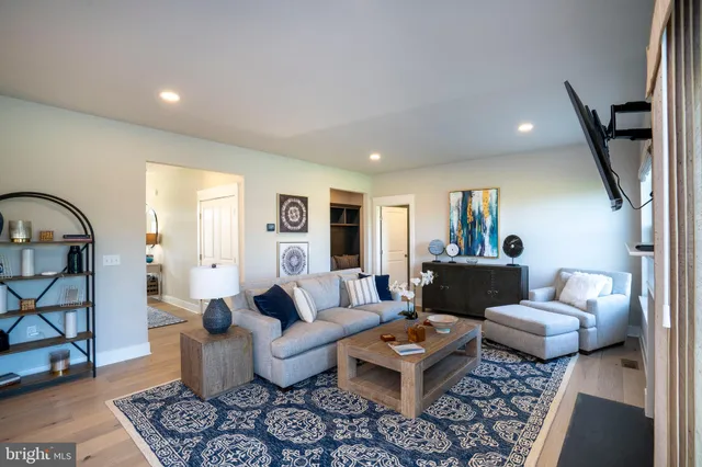 a view of a hallway with dining room and chandelier