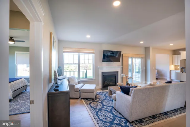 a spacious bedroom with a bed window and couch