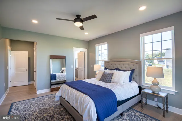 a spacious bathroom with a double vanity sink large mirror and a bathtub