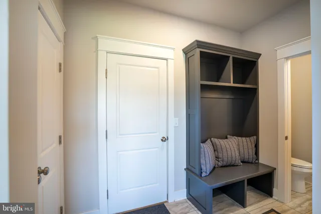a bedroom with a bed and chandelier