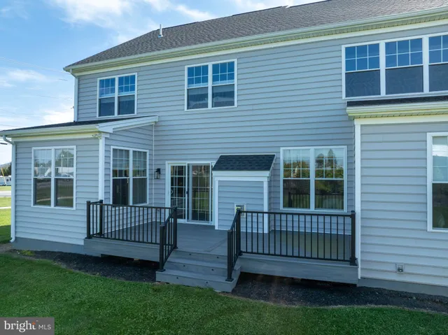 a dining room with furniture a chandelier and wooden floor