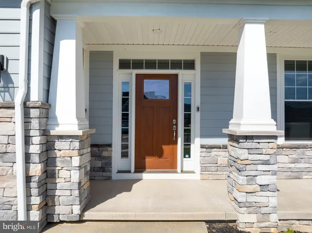 a kitchen with a stove a sink a dining table and chairs