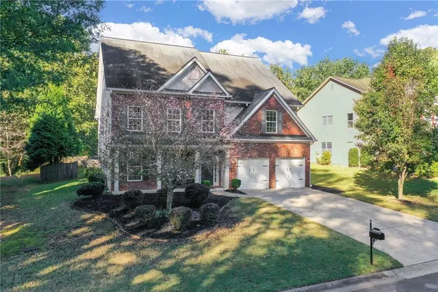 a view of a room with wooden floor and kitchen view