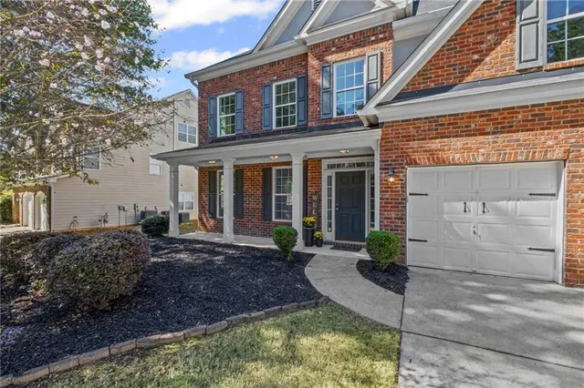 a kitchen with stainless steel appliances granite countertop a refrigerator stove top oven and sink with wooden floor