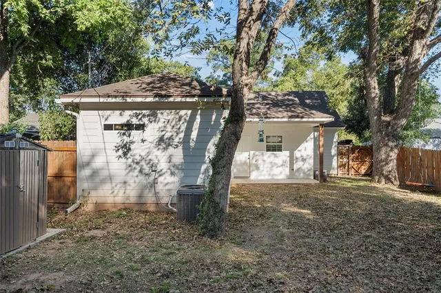 a backyard of a house with table and chairs